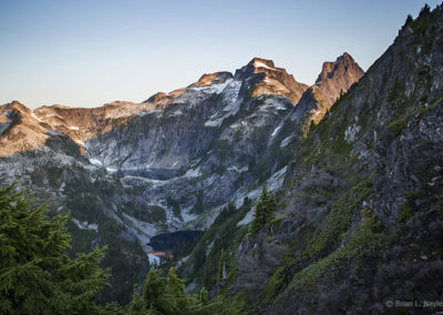 Alpine lake surrounded by morning peaks