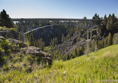 Bridge over wooded canyon and country fields