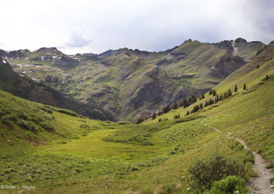 Path into green valleys and distant hills