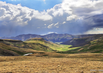Pastoral countryside under dramatic skies