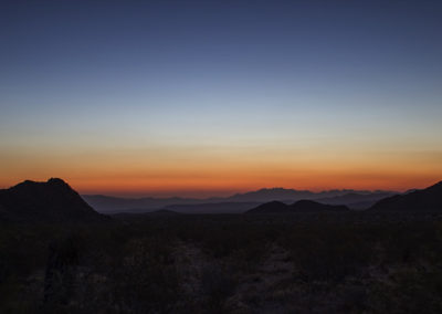 Predawn light over distant mountains